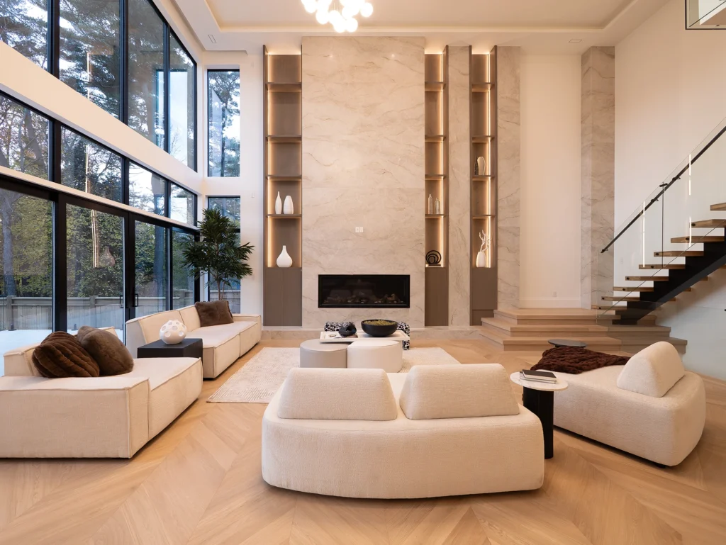 Double-height great room with floor-to-ceiling windows and stone fireplace — Mona custom home by Studio Kimi