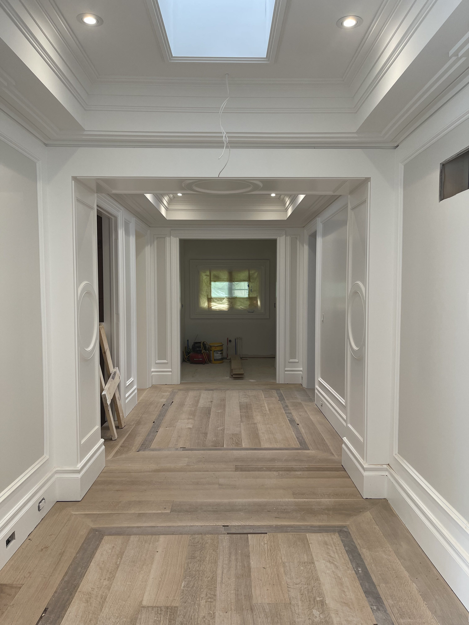 Bayview Ridge hallway during construction with oak floors — Studio Kimi interior design in Toronto