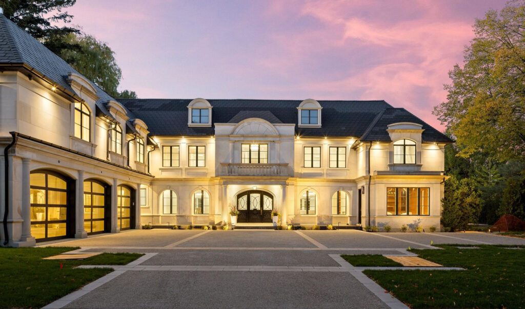 Bayview Ridge limestone exterior at dusk — Studio Kimi interior design in Toronto