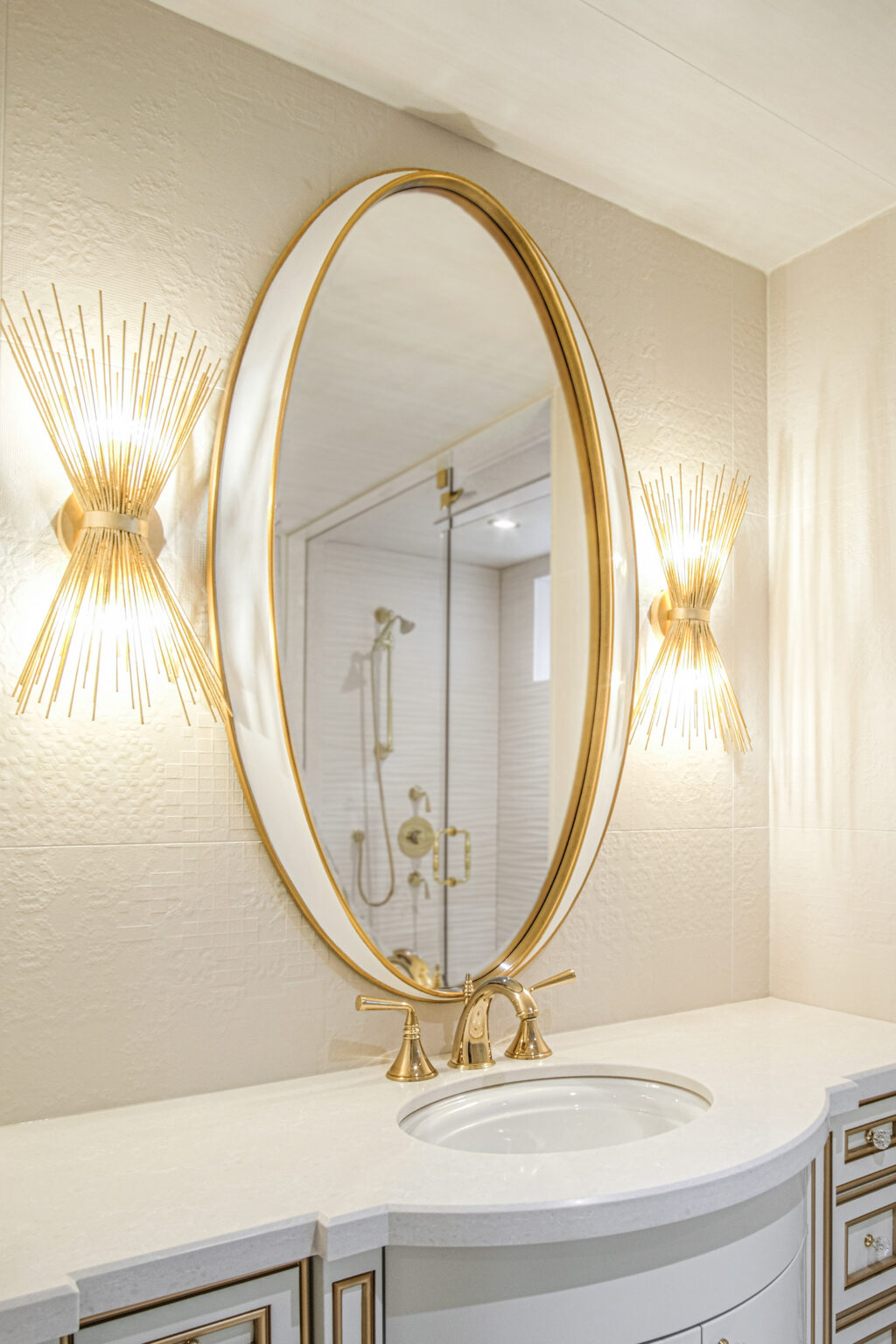 Bathroom vanity with gold oval mirror and sconces — Burrowhill, Studio Kimi Mississauga