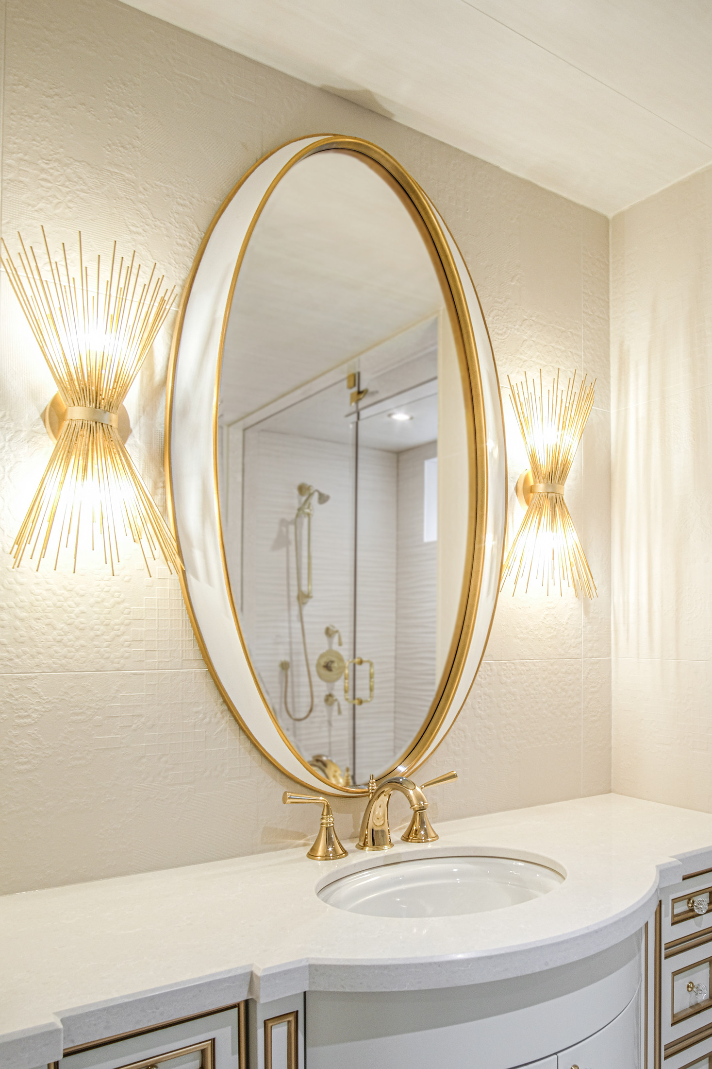 Bathroom vanity with gold oval mirror and sconces — Burrowhill, Studio Kimi Mississauga
