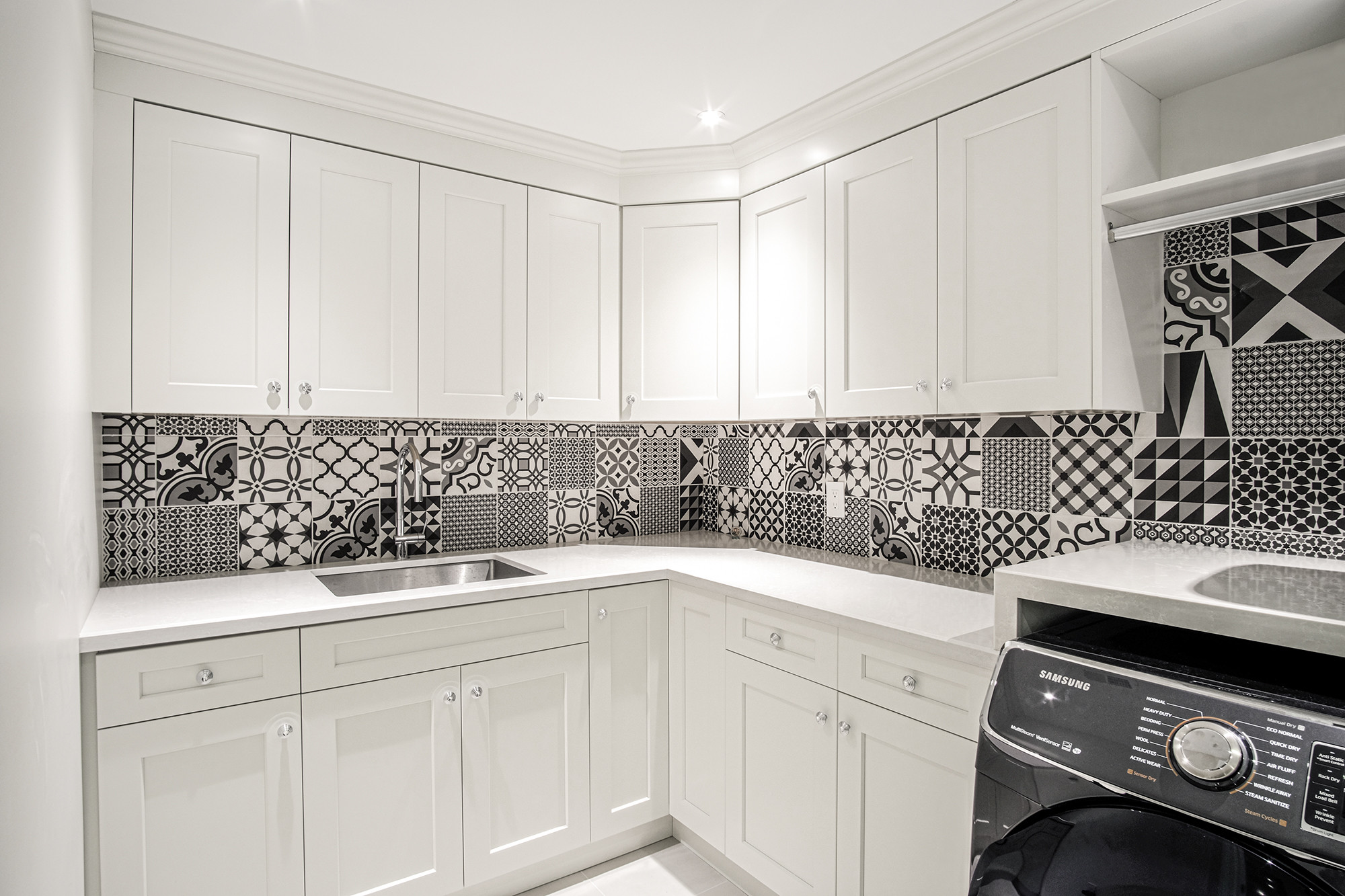 Basement laundry room with patterned backsplash — Burrowhill, Studio Kimi Mississauga