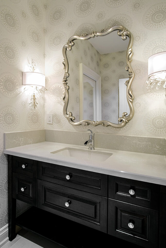Powder room with dark vanity and decorative mirror - Burrowhill, Studio Kimi Mississauga