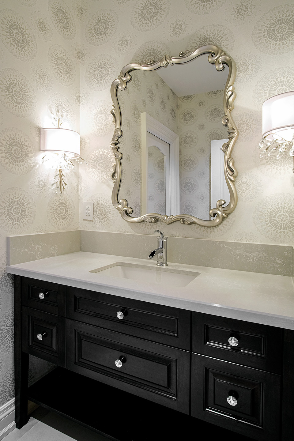 Powder room with dark vanity and decorative mirror — Burrowhill, Studio Kimi Mississauga