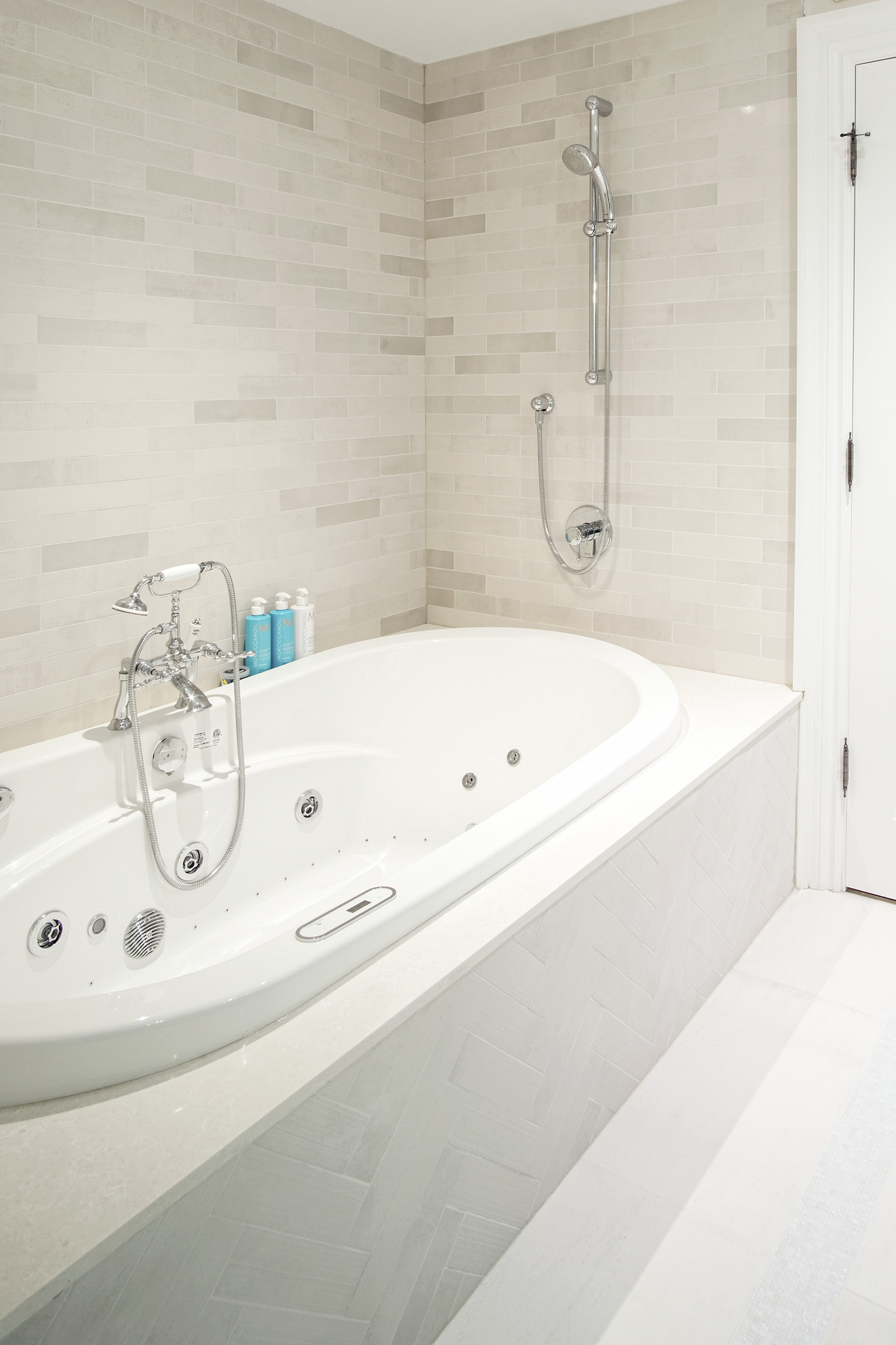 Jetted soaker tub with marble surround — Burrowhill basement bathroom, Studio Kimi Mississauga
