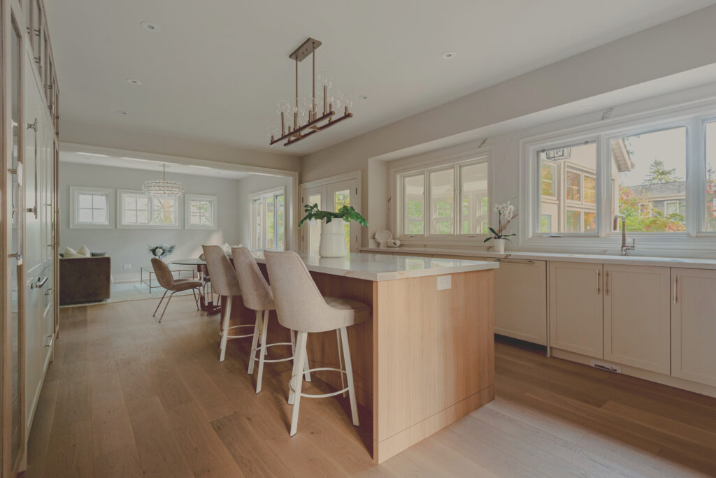Renovated white-oak kitchen with a quartz island, open to the dining area, in a Duncan home by Studio Kimi
