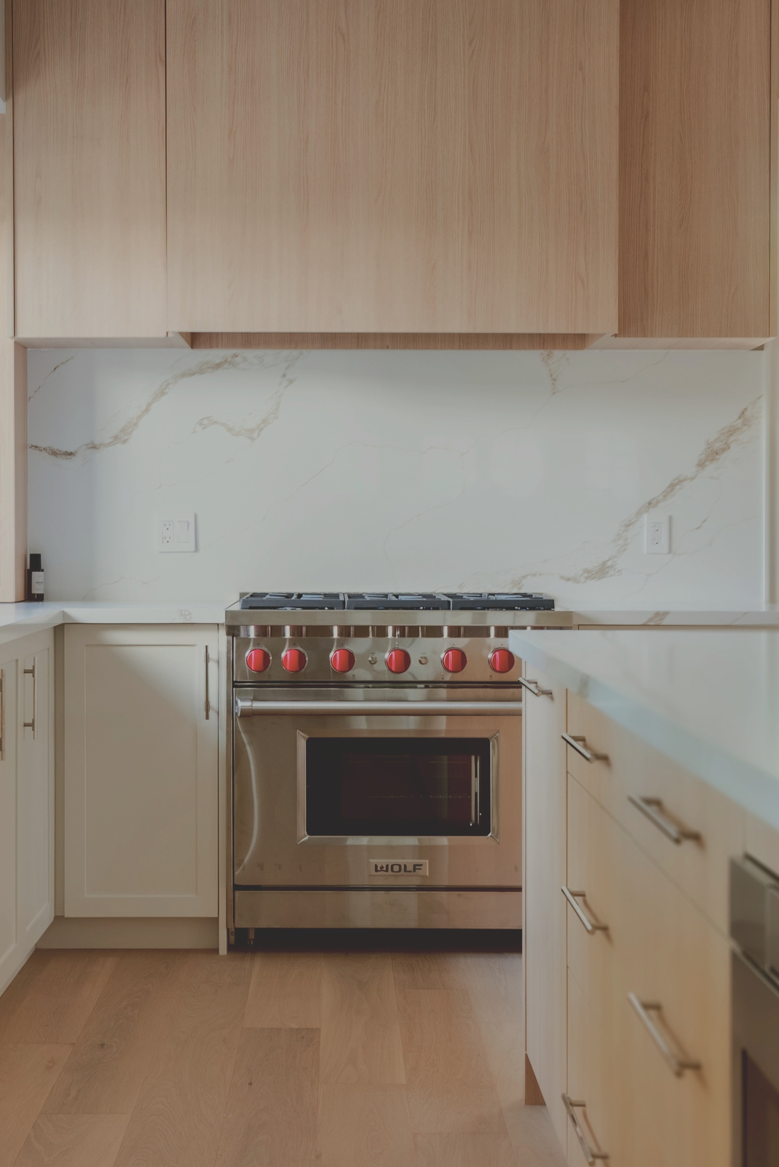Duncan kitchen with oak cabinetry and range — Studio Kimi Oakville