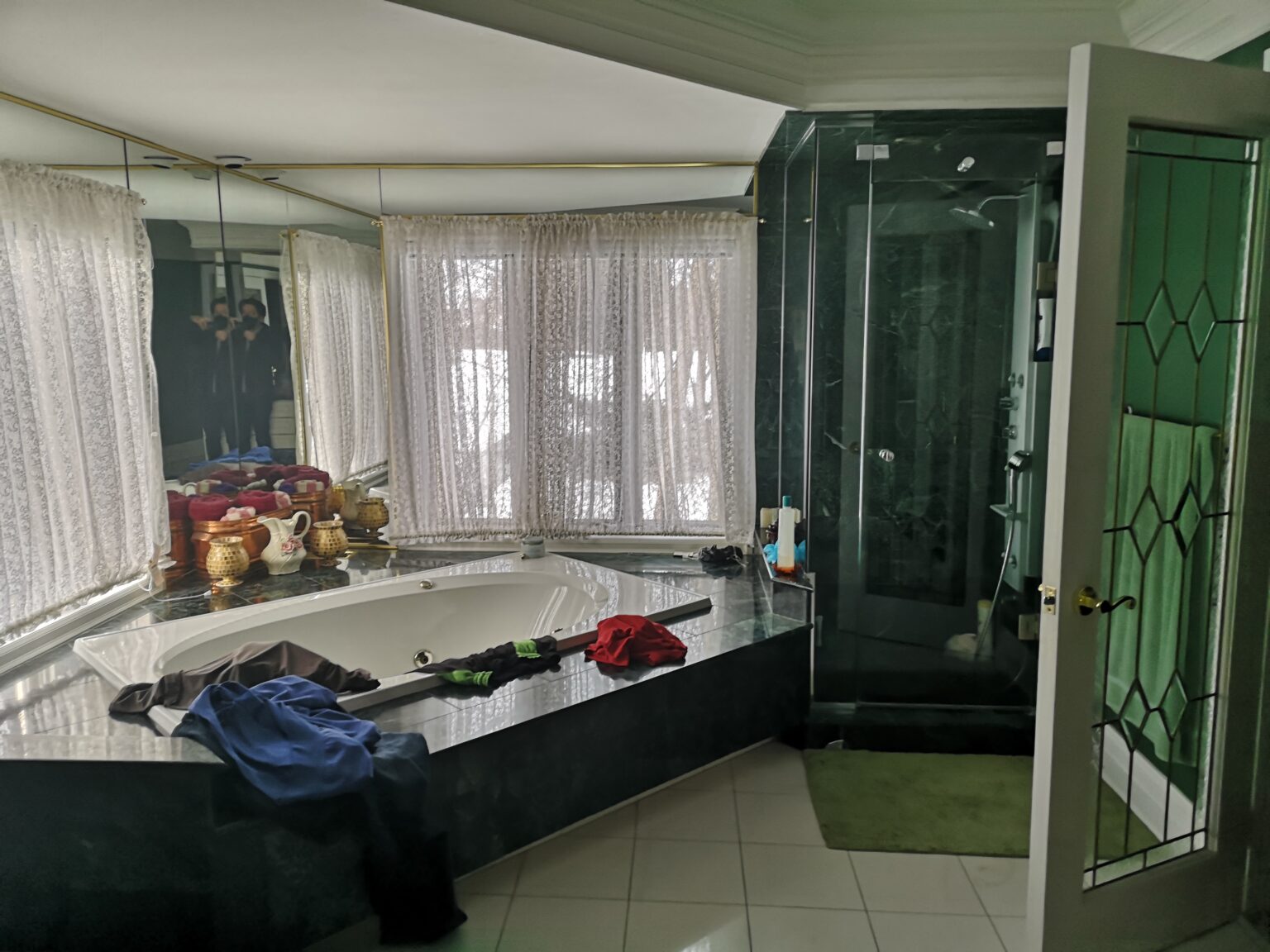 Gregwood primary ensuite before renovation — original green-marble tub and glass shower, Lorne Park, Mississauga