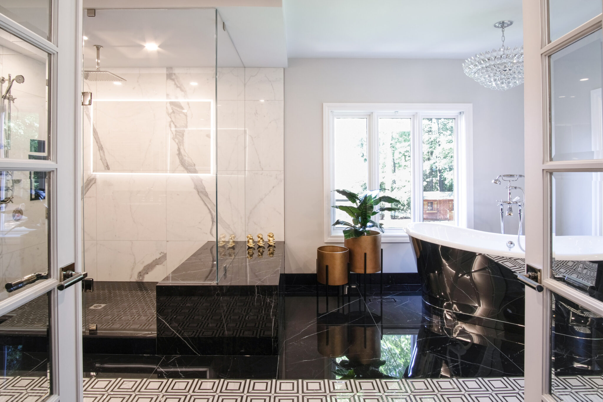 Marble glass shower and black freestanding tub under a chandelier — Gregwood ensuite, Lorne Park, Mississauga — Studio Kimi Interior