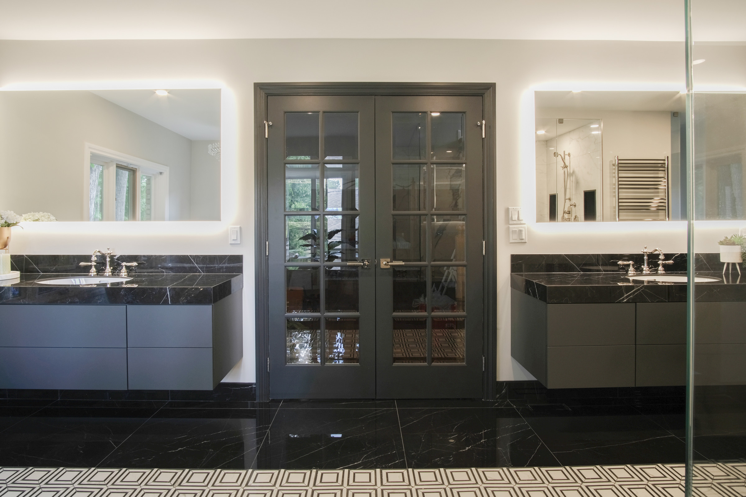 Charcoal floating double vanity with backlit mirrors and brass fixtures, Gregwood ensuite