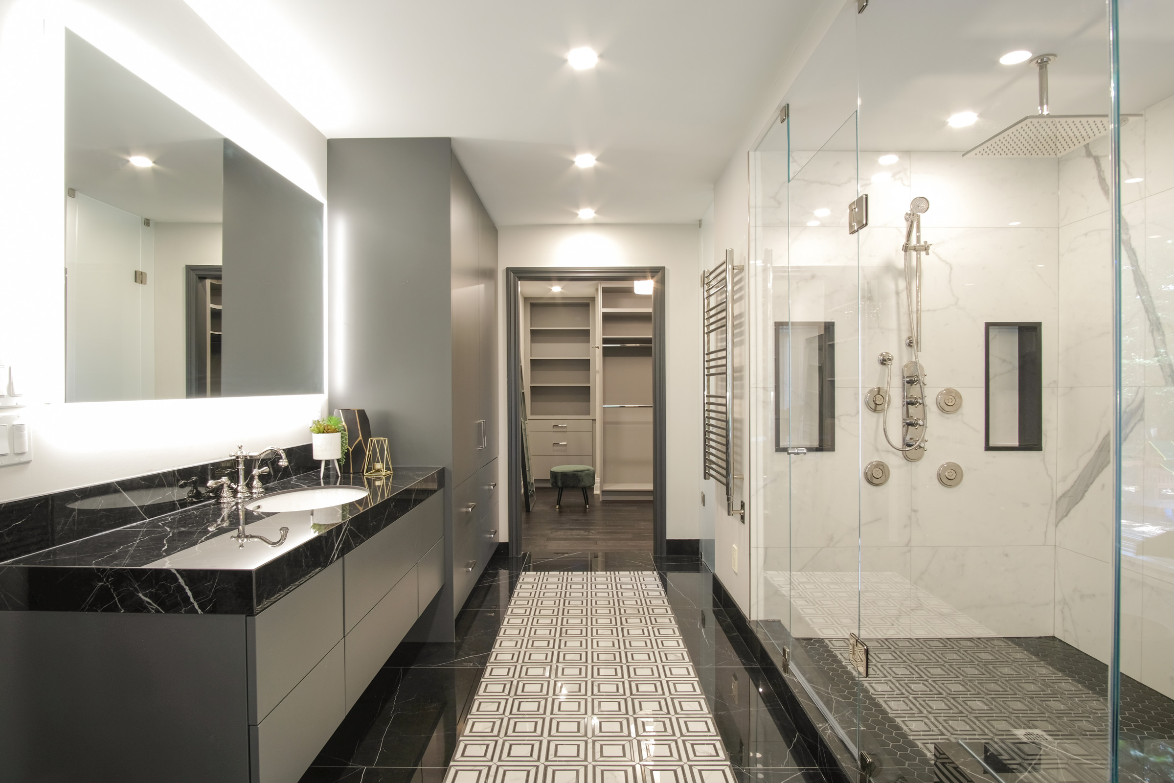 Marble walk-in shower opening to the fitted walk-in closet, Gregwood primary suite