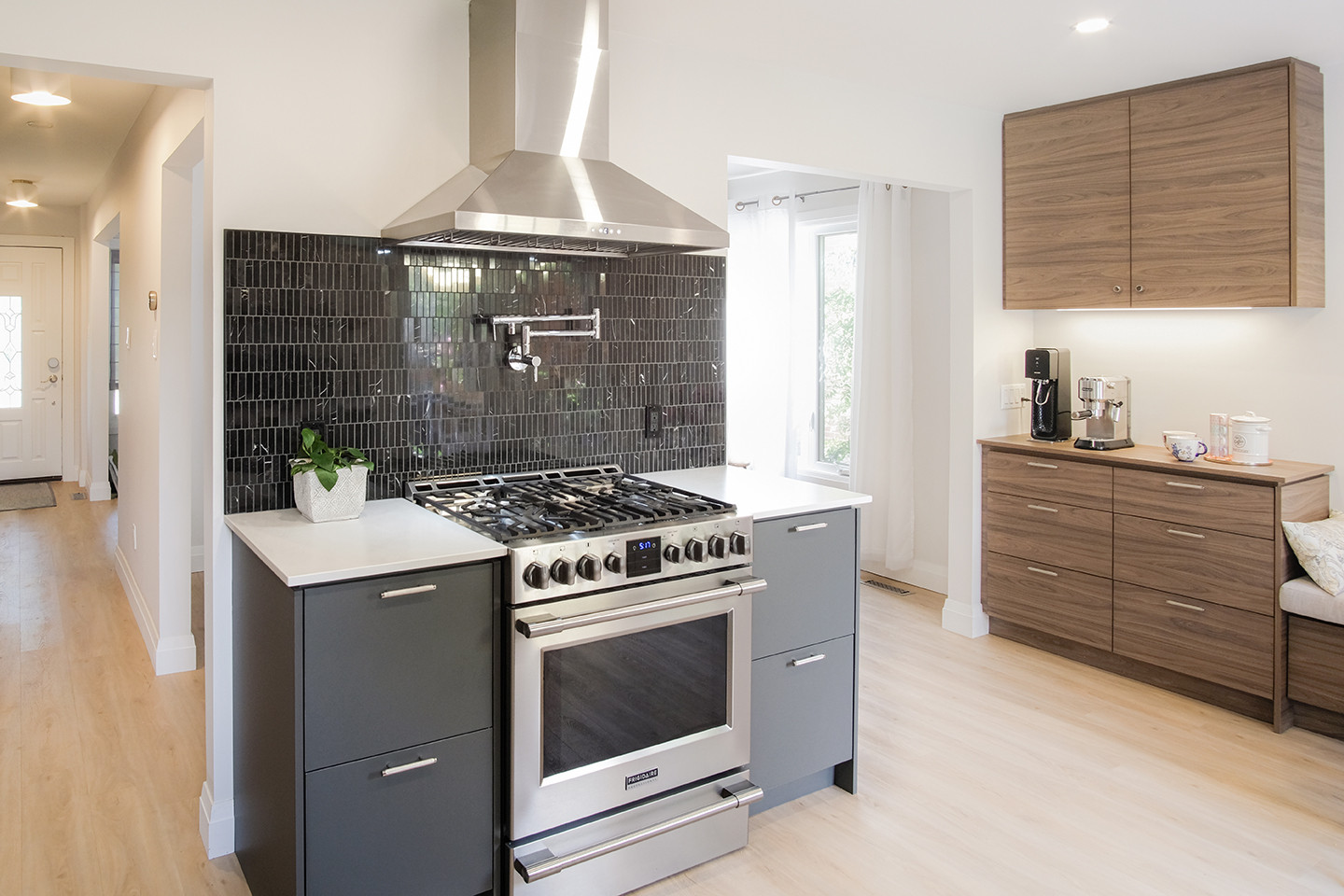 Stainless range and hood against the dark tile backsplash — Ingram kitchen, Studio Kimi Mississauga