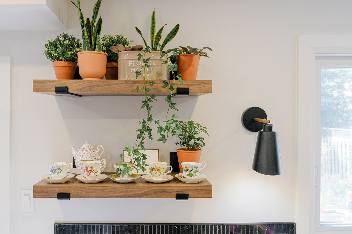 Wood shelf detail with potted plants and a black sconce — Ingram, Studio Kimi Mississauga