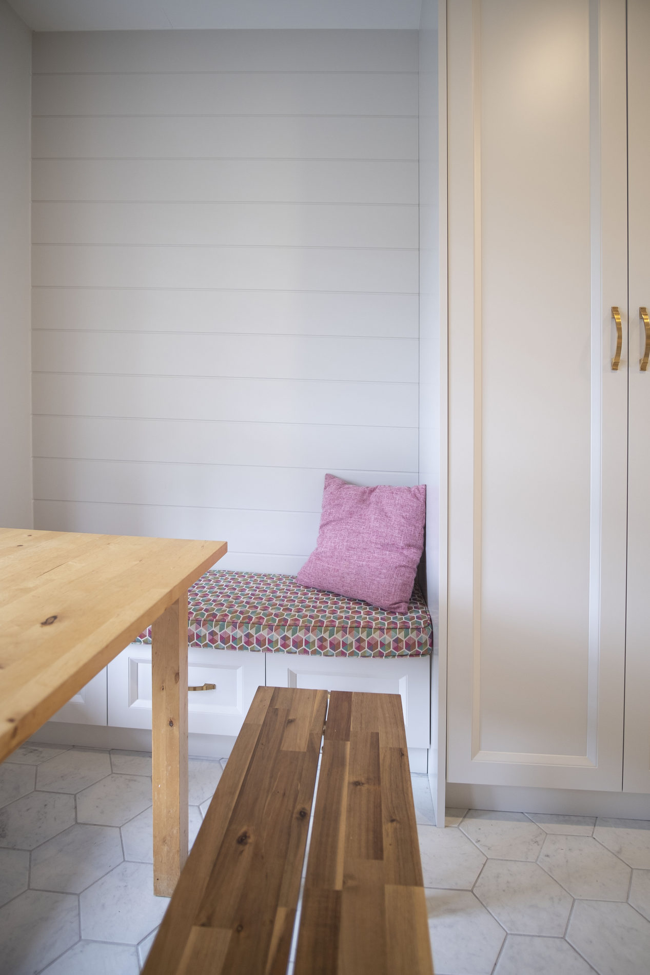 Built-in breakfast nook bench by the window in an Etobicoke renovation by Studio Kimi