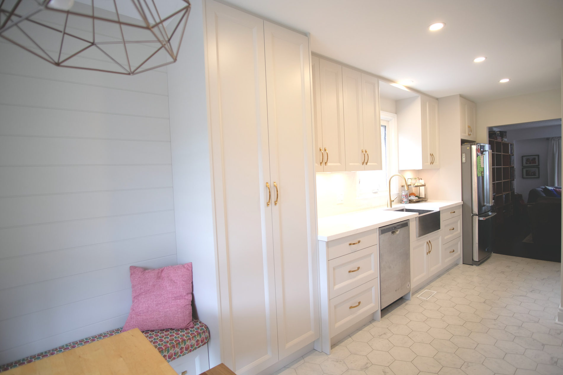 Entry with bench seating and storage cabinetry in an Etobicoke renovation by Studio Kimi