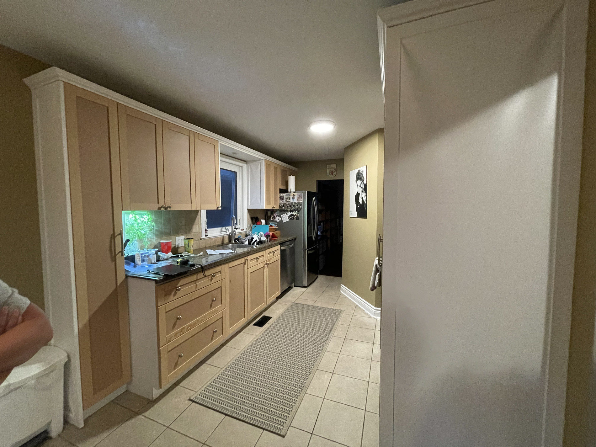 Murrie kitchen before renovation, with dated oak cabinets and a galley layout