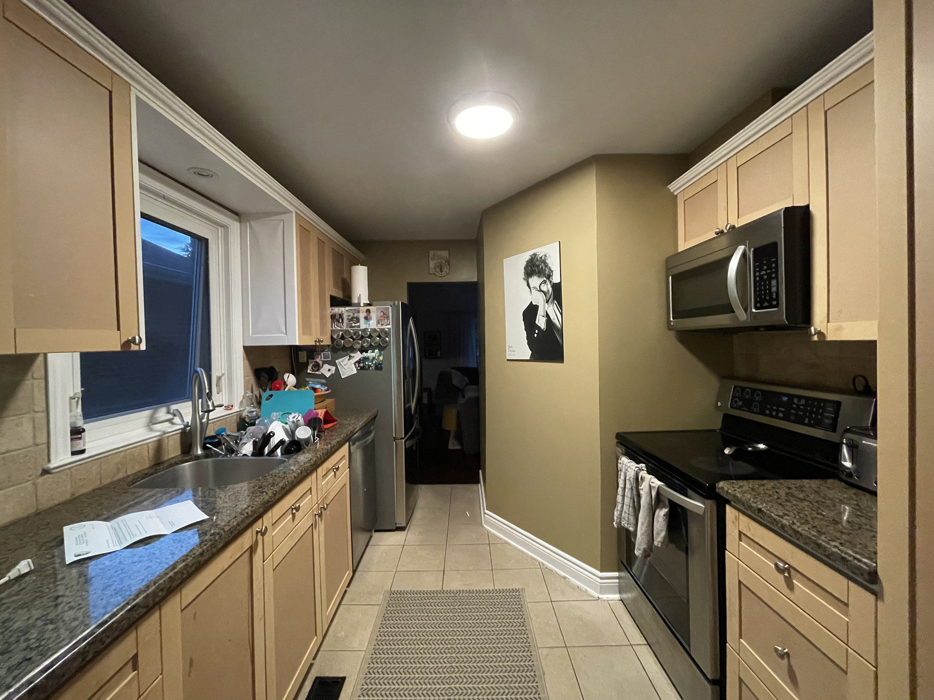 Murrie kitchen before renovation, with original oak cabinets and black appliances