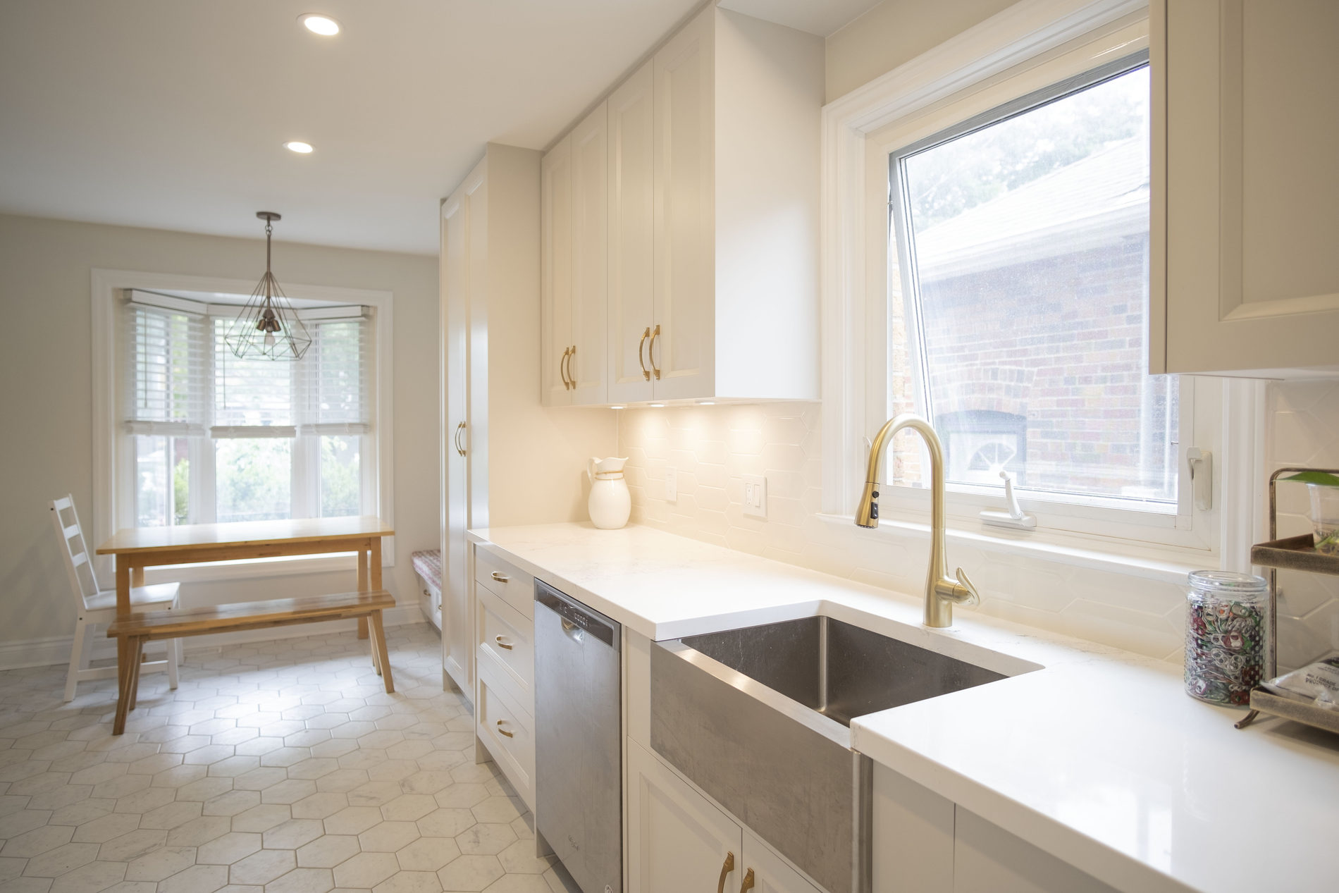 Kitchen sink and window with quartz counters in an Etobicoke main-floor renovation by Studio Kimi