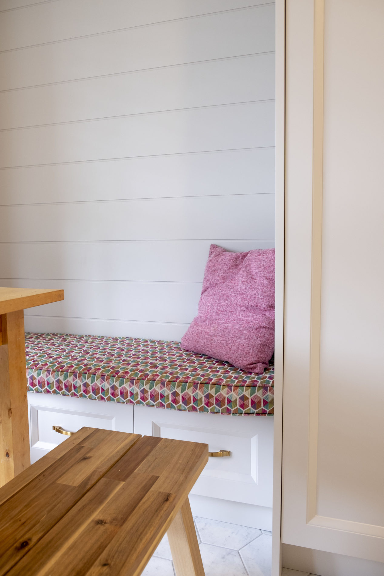 Window bench seating with cushions in an Etobicoke renovation by Studio Kimi