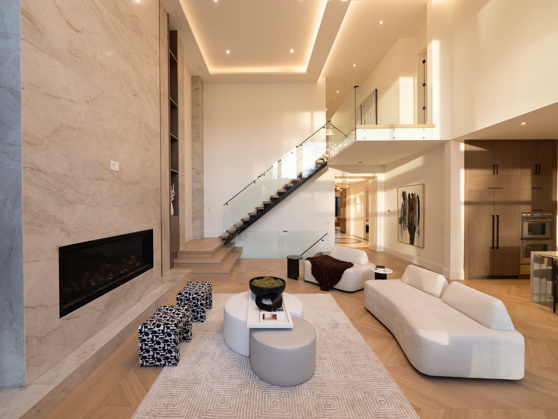 Studio Kimi interior design — double-height living room with a marble fireplace, Mona project in Mississauga