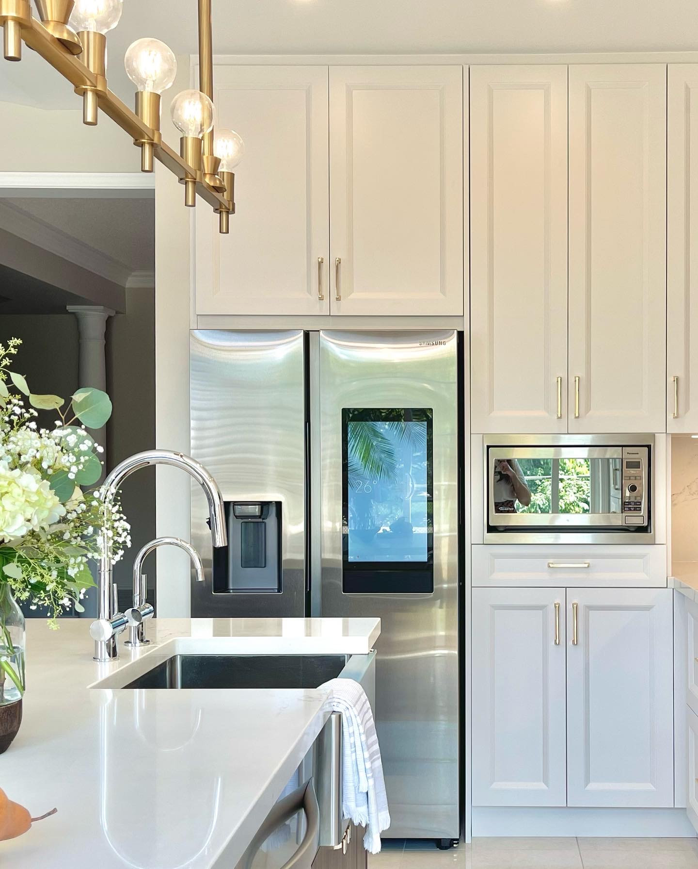 Integrated fridge and prep sink in white cabinetry
