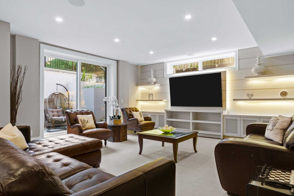 Renovated lower-level family room in an Oakville home by Studio Kimi