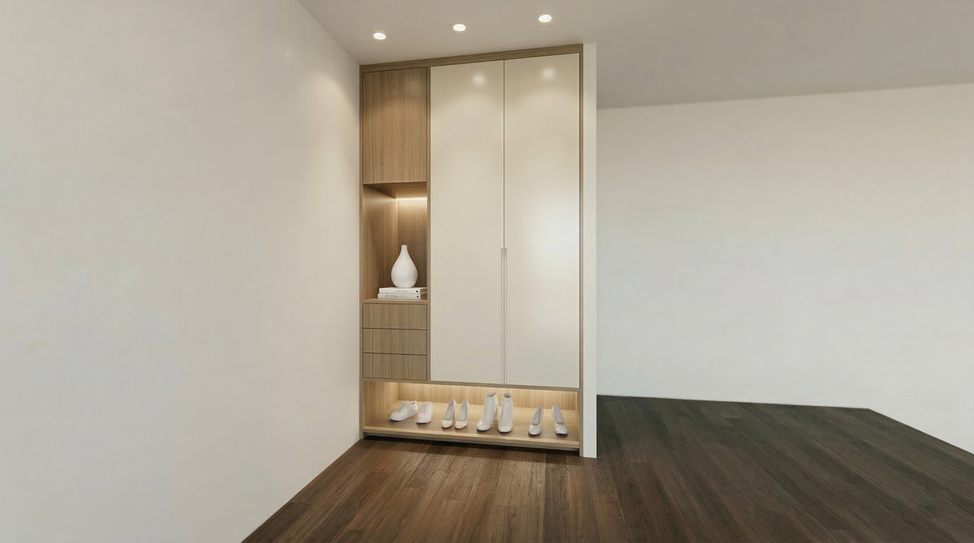 The bachelor unit's entry, with a lit niche and integrated storage — Studio Kimi