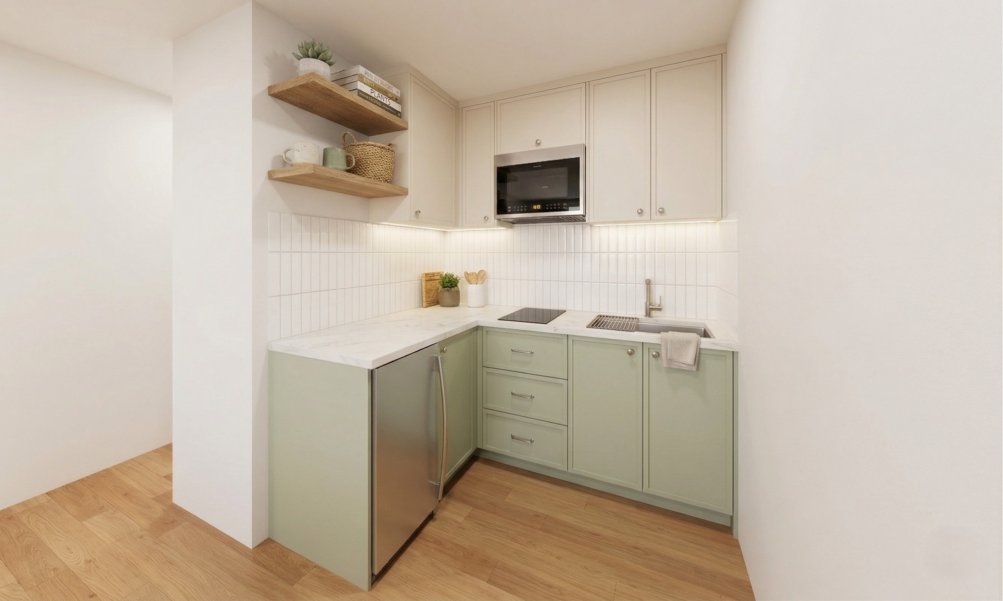 The bachelor unit's kitchen, in sage green with open oak shelving — Studio Kimi